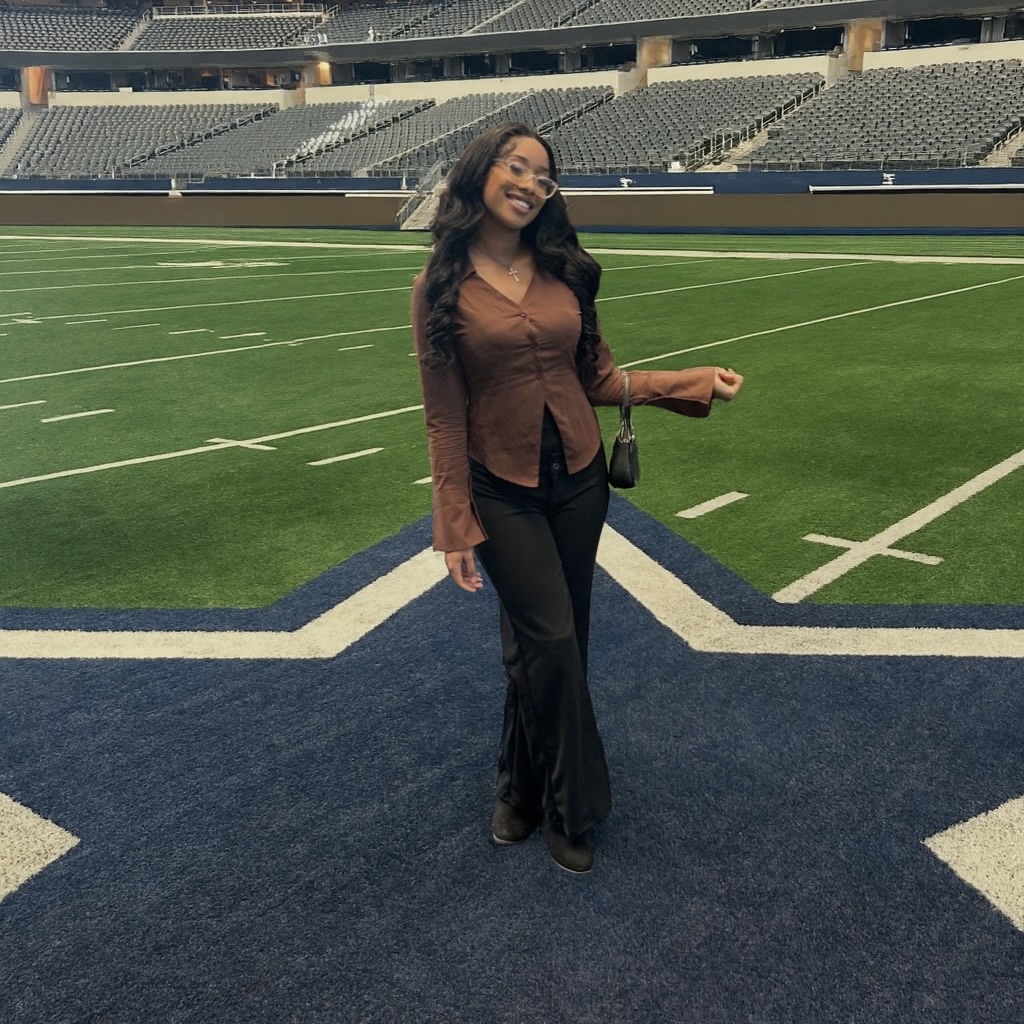 Shania standing on AT&T Stadium field